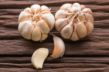 Garlic cloves on wooden vintage background.