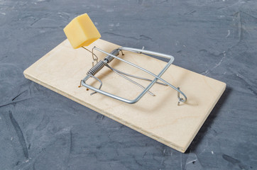 Wooden mousetrap on the concrete floor.