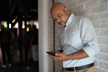 Fototapeta premium a man is using his smartphone