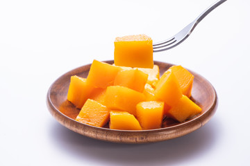 Fresh and beautiful mango in a wooden plate with sliced diced mango chunks isolated with   white background, copy space(text space), blank for text