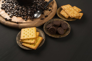 Pictures of coffee beans and snack on wooden backdrop You can decorate it in cafes, equipment, labels, or even for editing purposes.