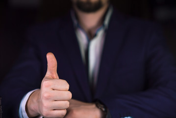 Businessman shows thumb up. Successful business concept
