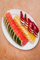 Delicious fruits to eat meal - watermelon, apples and pineapples.