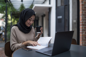 a muslim girl is doing some work