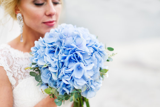 Beautiful bride with blue wedding bouquet