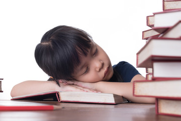 The girl is reading a book at the table.