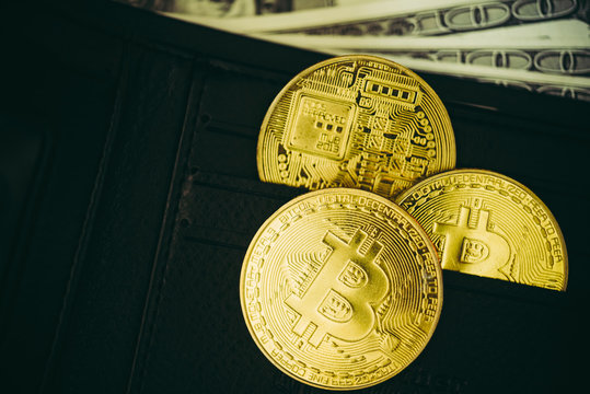 Metal bitcoins in black leather wallet.