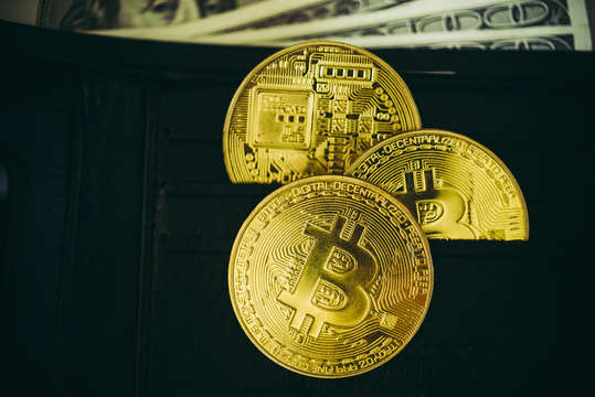 Metal bitcoins in black leather wallet.