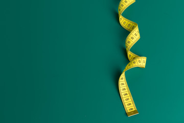measure tape on a green background