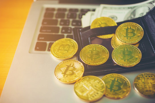 Metal bitcoins in black leather wallet.