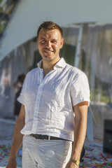 Man with smile standing happy having a good time after party outdoor