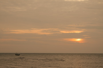 The boat in the sea during the sunset