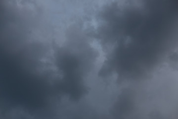 gray and pink clouds against the blue sky