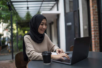 a muslim girl is doing some work