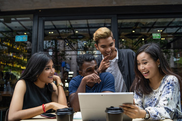 a group of multi culture friends discussing work at cafe