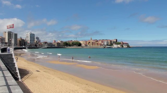 People Frolicking and Strolling along Seashore
