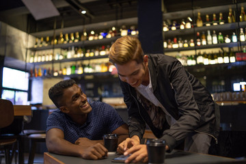 two multi culture man is doing work at cafe