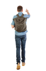 Back view of a walking man with a bag pointing his hand up.