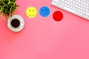 Customer satisfaction concept. Emoji smile, neutral, sad on work desk on pink background top view copy space