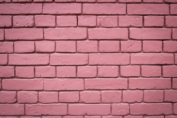 The texture of a wall of painted red brick
