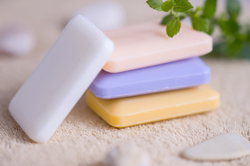 four bars of soap on a towel