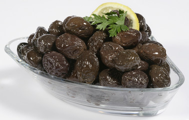 black olives at bowl isolated on white