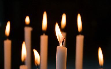 Devotional candles lit inside a church.