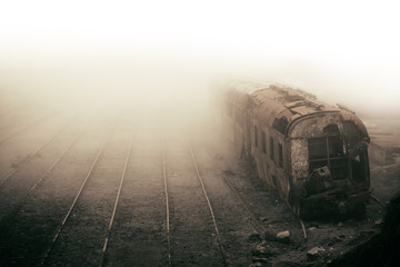 Abandoned rusting train and empty train tracks photographed in misty foggy day in the village Paranapiacaba, Sao Paulo, Brazil. Photo color toned with sepia for surreal and vintage nostalgic look. - Powered by Adobe