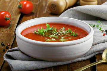 Delicious gazpacho and ingredients on a table. Vegetarian vegetable cold soup.