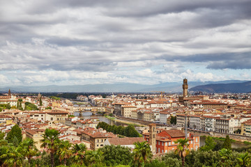 Obraz premium Picturesque view of Florence city with colorful old buildings under dark clouds, Italy