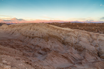 Fototapeta na wymiar Valle de la Luna (Valley of the Moon) landscape in the Atacama Desert, north of Chile. The wilderness and desolation resembles the surface of Mars or the Moon. Volcano mountains in the background.