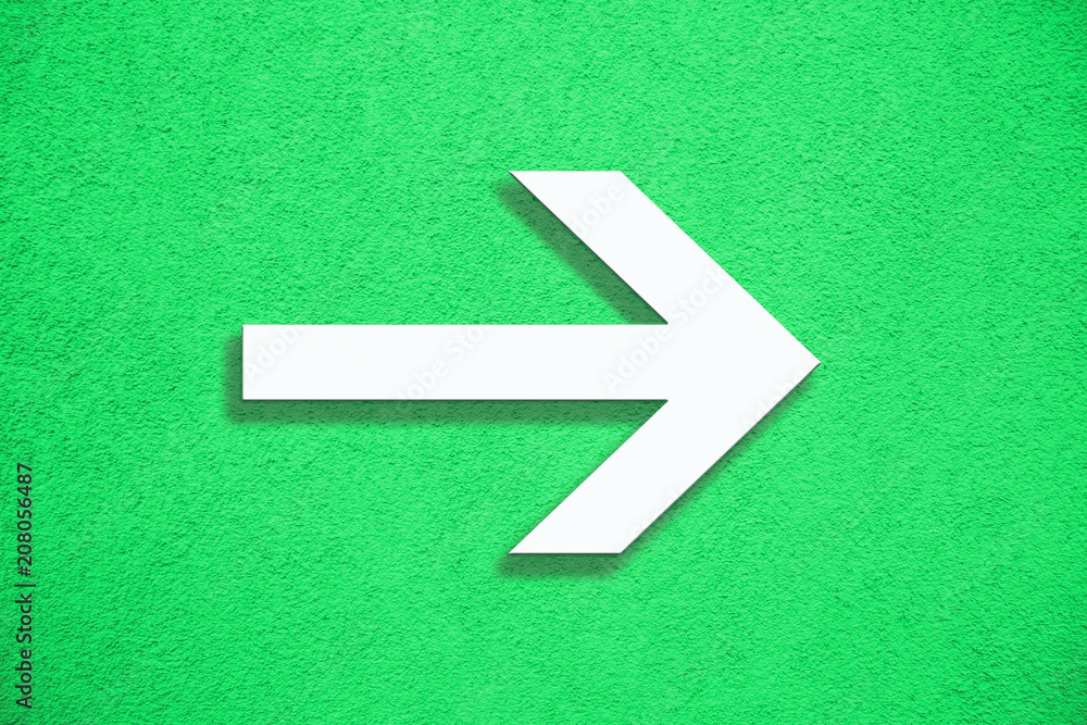 Poster white arrow direction sign over vivid bright green color stucco rough wall as an empty rustic and si