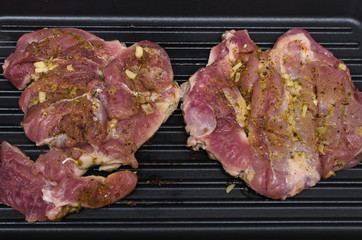 Raw turkey meat on the cooking pan. Preparation of grilled meat.