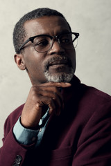 portrait of thoughtful african american man in trendy eyeglasses