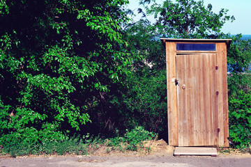 Old funny wooden toilet. Toilet in the household. Outside washroom for visitors or tourists and travelers at a forest