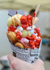 Street food : ice cream with strawberiies, chocolate chips, marshmelous, and waffles 