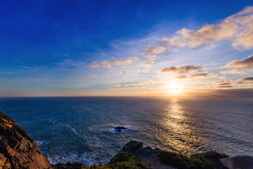 An incredible sunset in the cloud that is visible from a high hill on the beach