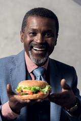 smiling middle aged african american man with hamburger