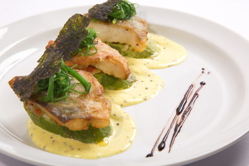Fried fish on slices of Zucchini