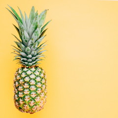 Pineapple on a yellow background. Summer concept. Flat lay, top view, copy space, square 