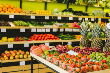 Fototapeta na wymiar Seasonal and exotic fruits and vegetables on the food shelf in the supermarket