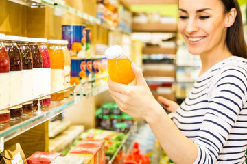 Beautiful Young Woman Groceries Shopping In Local Supermarket