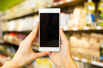 Beautiful Young Woman Groceries Shopping In Local Supermarket