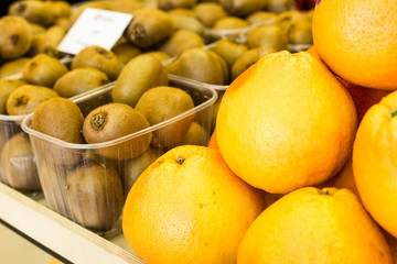 Citrus Fruits is a healthy diet. Fresh and ripe orange in a box on a shelf in a grocery store.