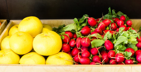 Seasonal and exotic fruits and vegetables on the food shelf in the supermarket