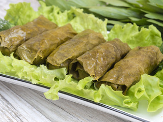 meat rolls in grape leaves on a kitchen table. 
