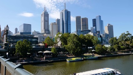 Sliding shot of Melbourne downtown skyscrapers and the Yarra River from Princes Bridge