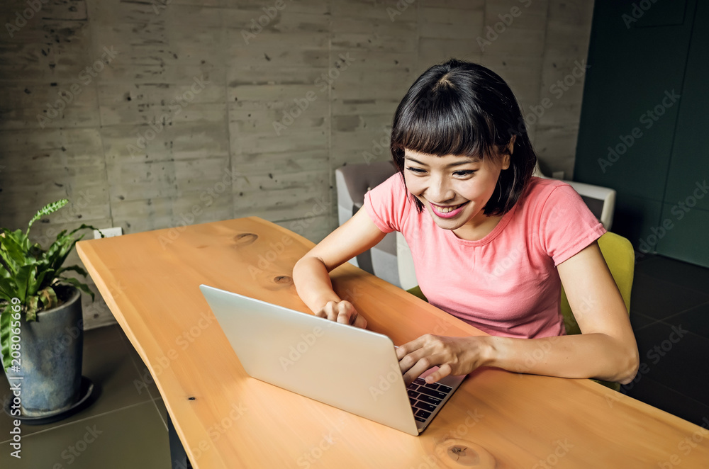 Wall mural woman using laptop