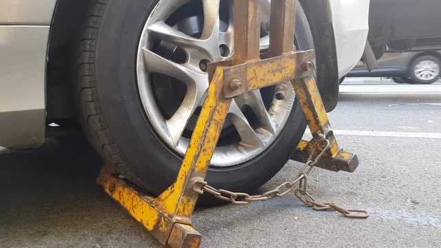 Wrecker towing car, vehicle fined for parking violations, evacuation service