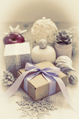 Surrealism Christmas composition with gift box with satin ribbon bow materials for decorating Christmas toy bump.